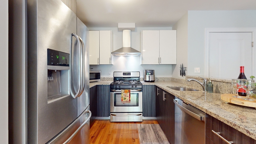 a kitchen with stainless steel appliances granite countertop a stove and a sink