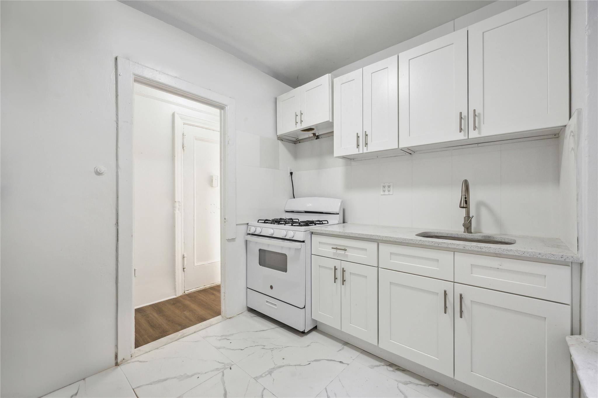 a kitchen with white cabinets