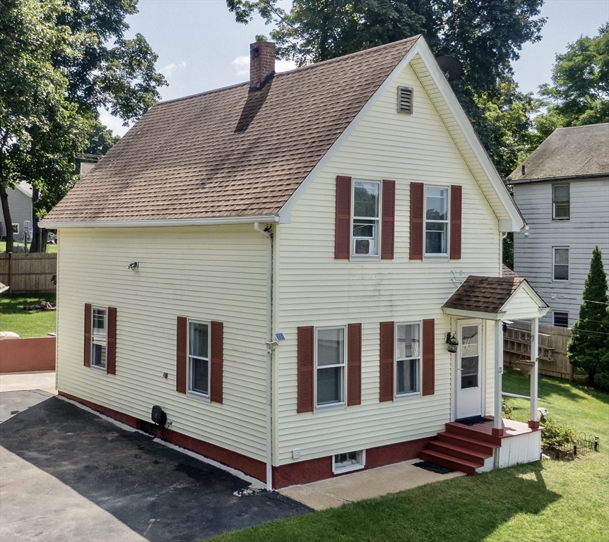 a view of house with backyard