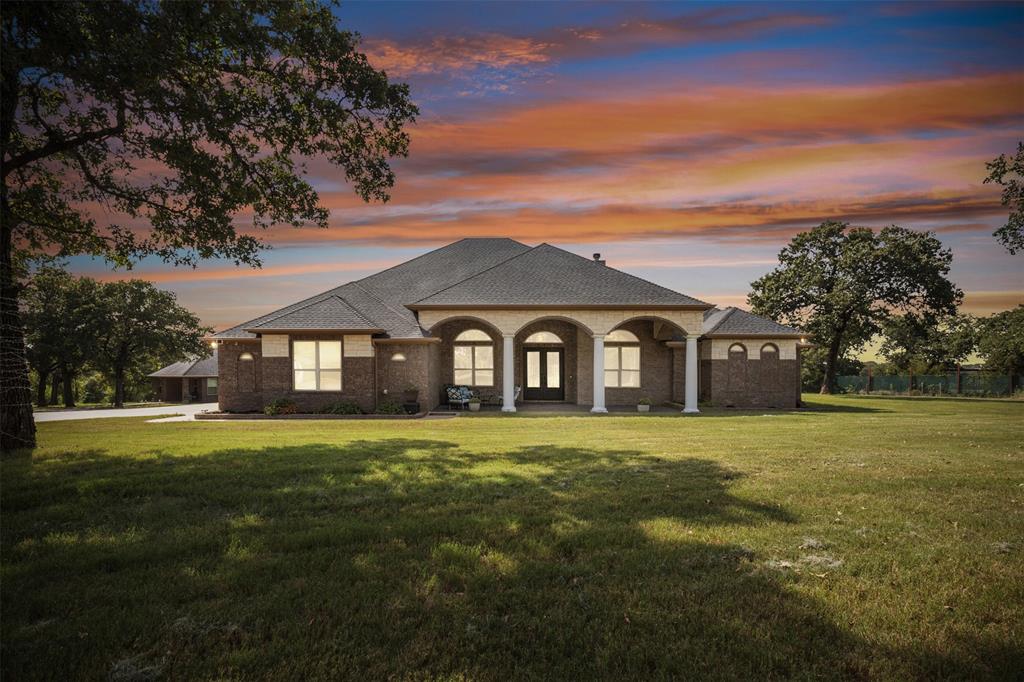 a front view of a house with a big yard