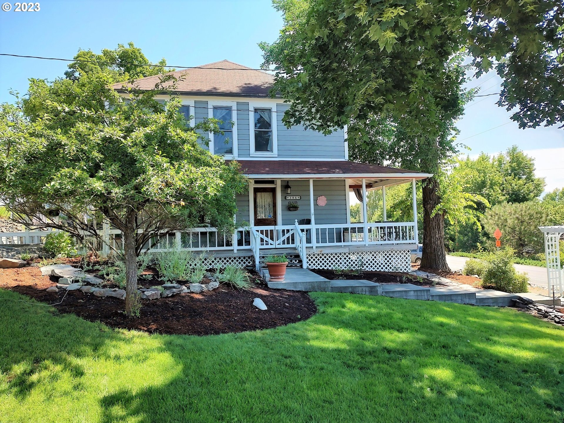 a view of a house with a yard and sitting area