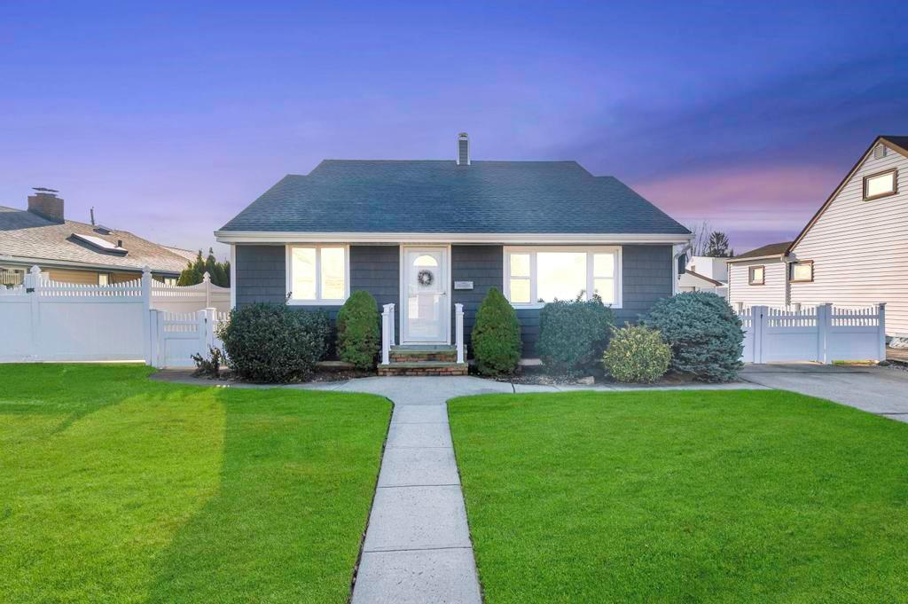 Bungalow-style house featuring a lawn