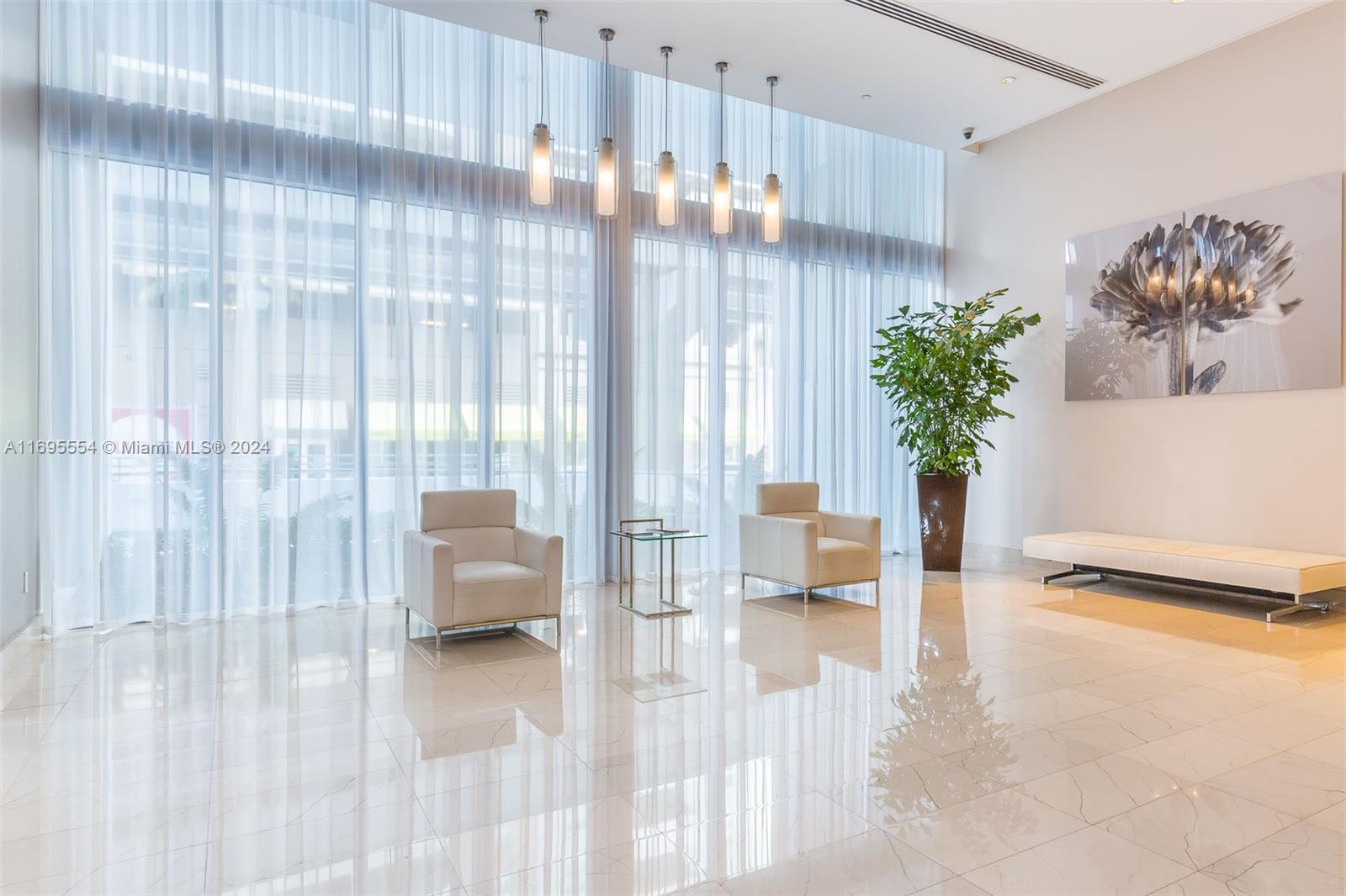 a living room with furniture and a potted plant