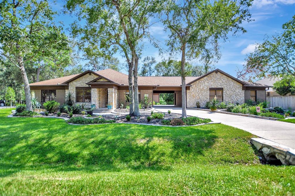 a front view of a house with yard patio and green space