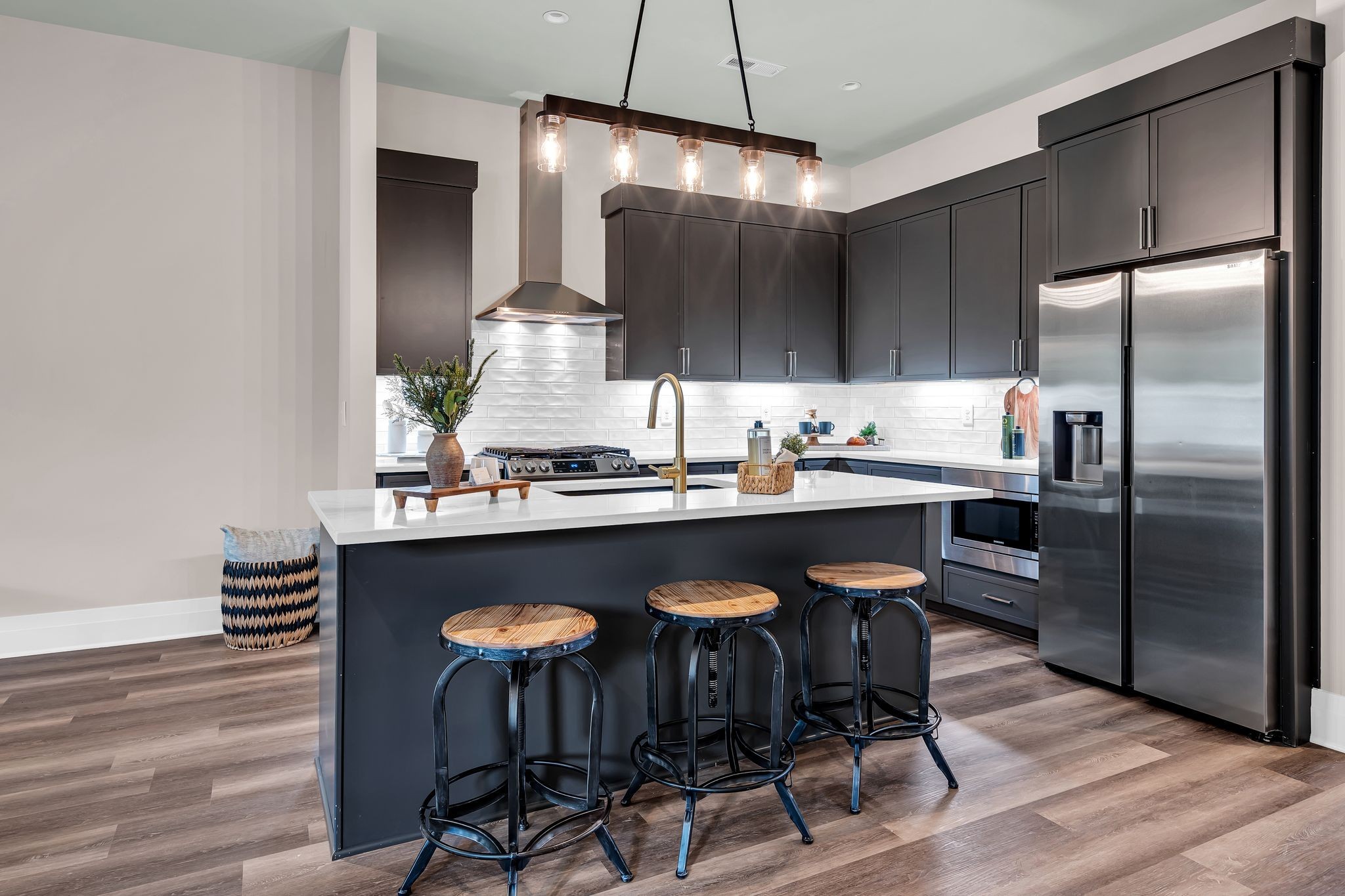 a kitchen with a table chairs refrigerator and microwave