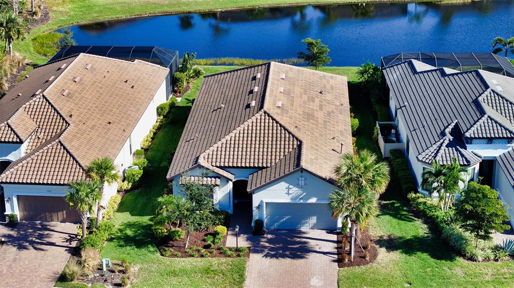 an aerial view of a house with a yard and a patio