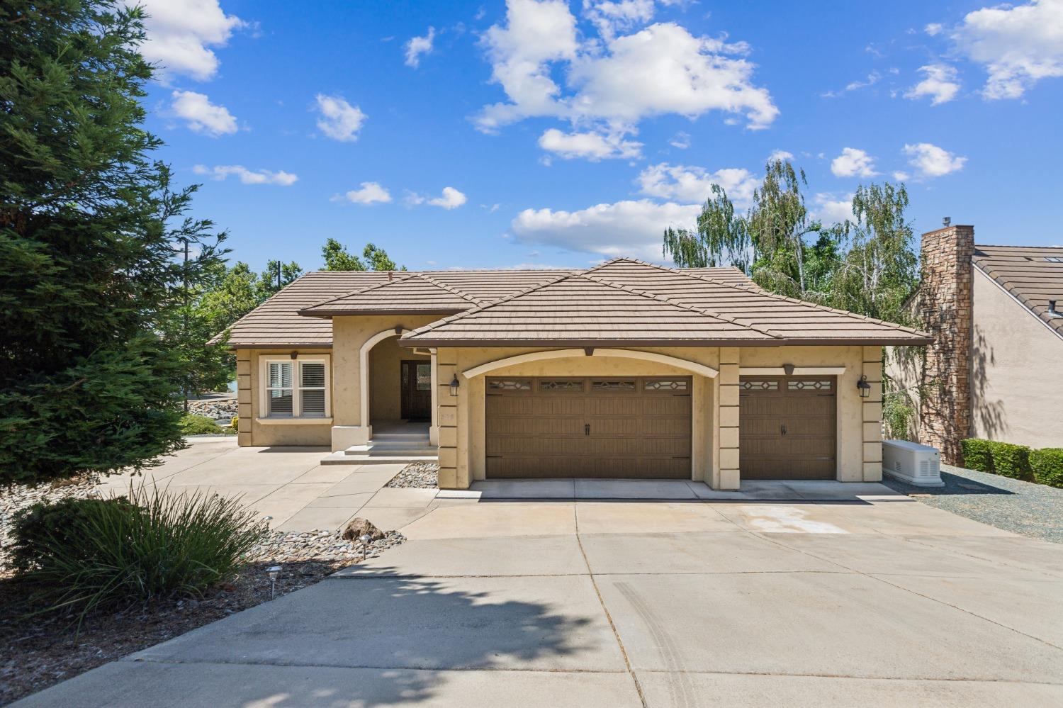 a front view of a house with a garden