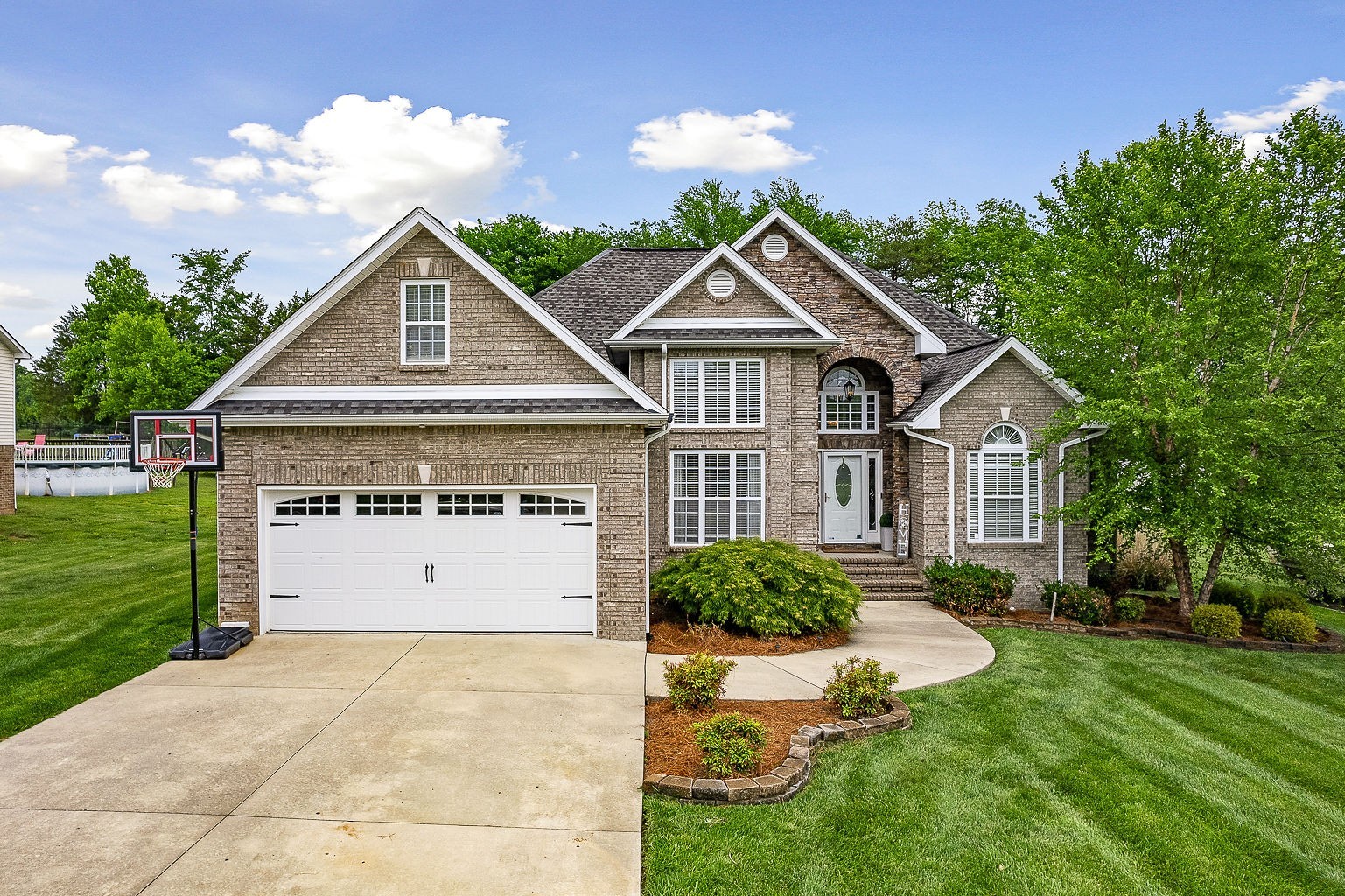 a front view of a house with a yard and garage