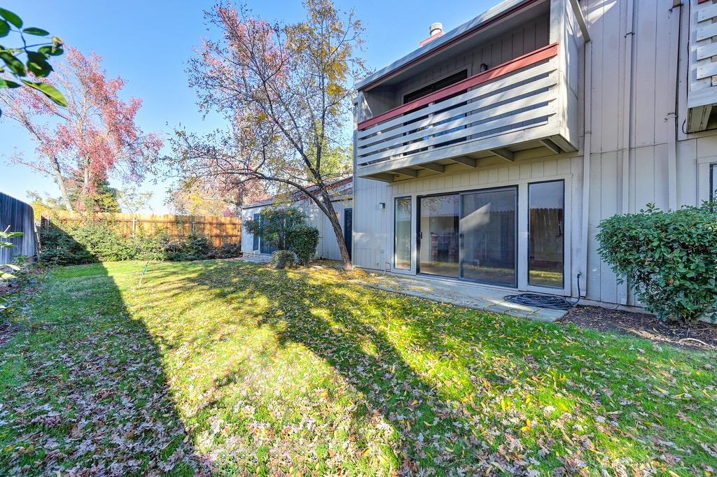 a view of house with a yard