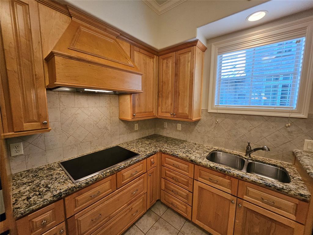 a kitchen with granite countertop cabinets sink and stainless steel appliances