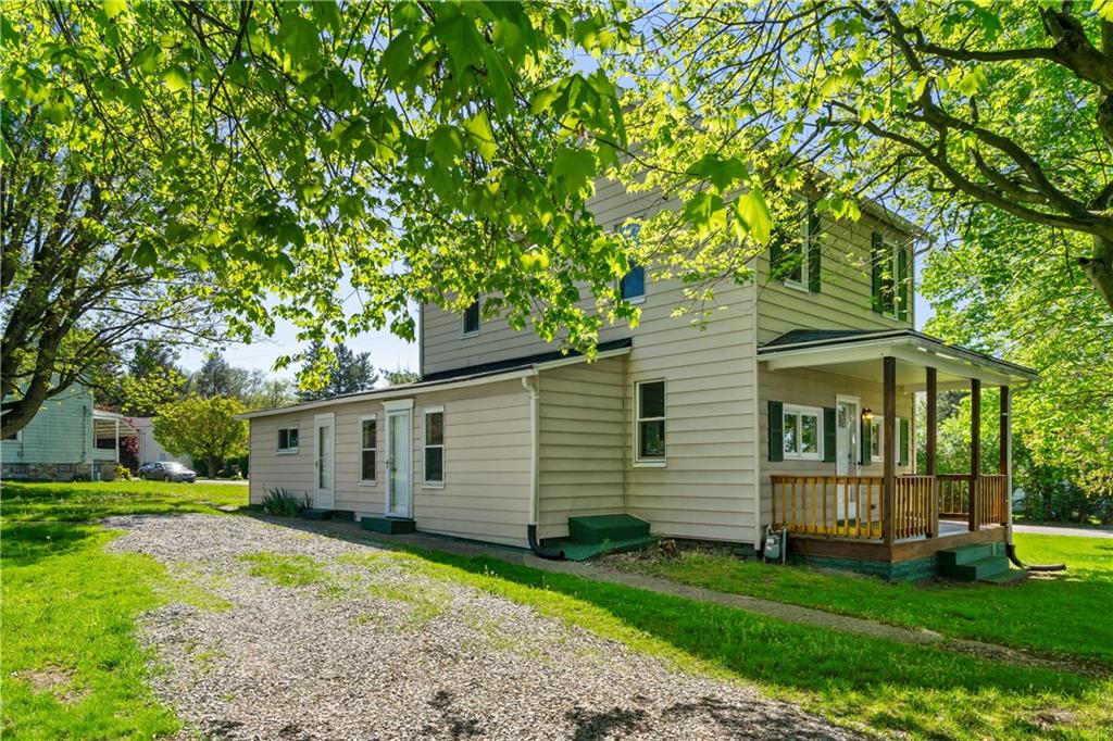 a front view of a house with a garden