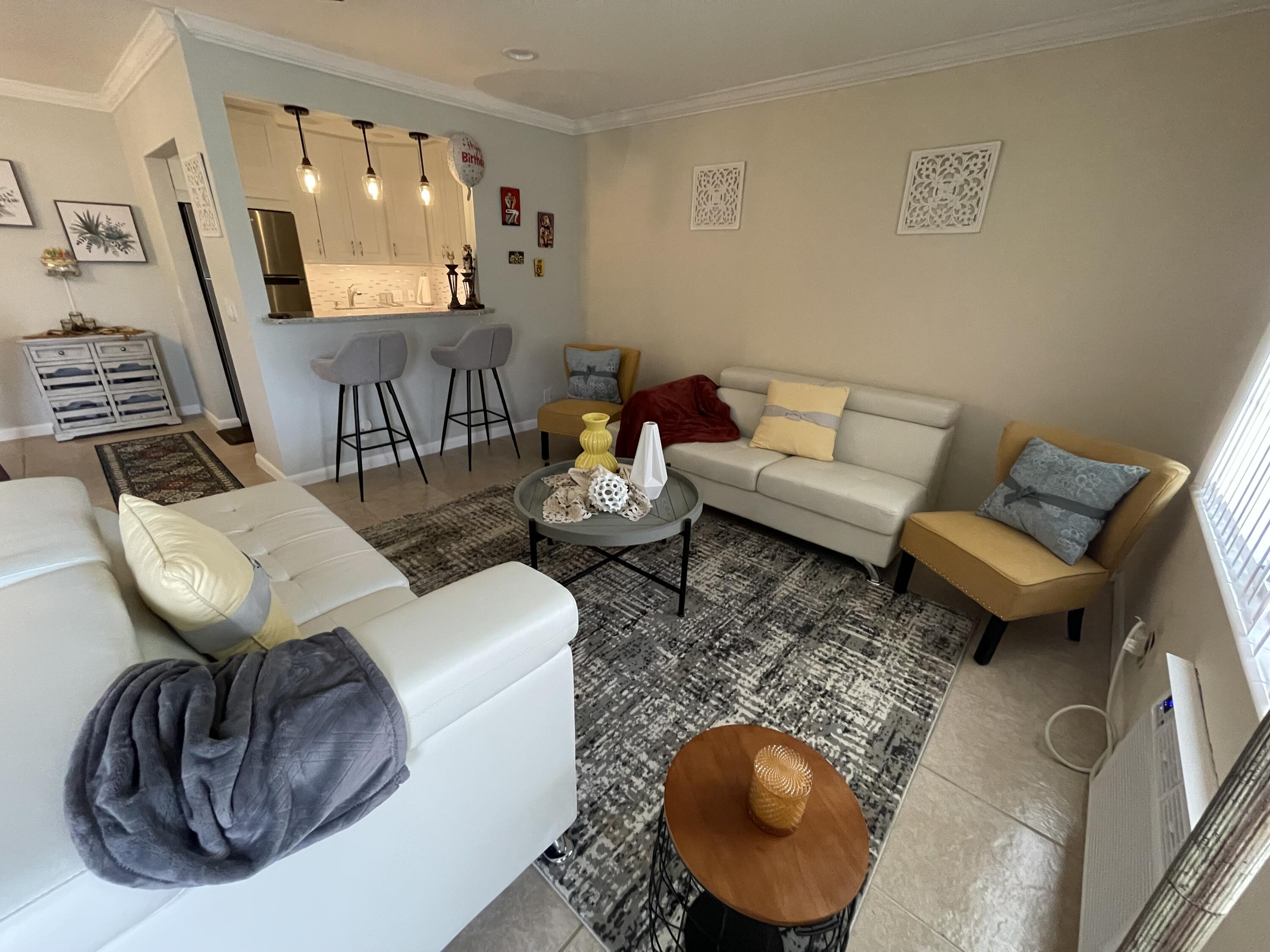 a living room with furniture and a mirror