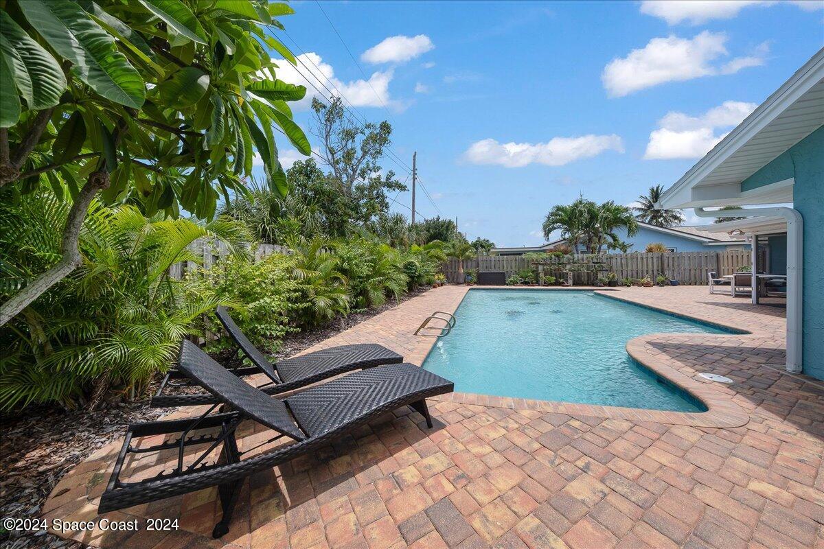 a view of a backyard with sitting area