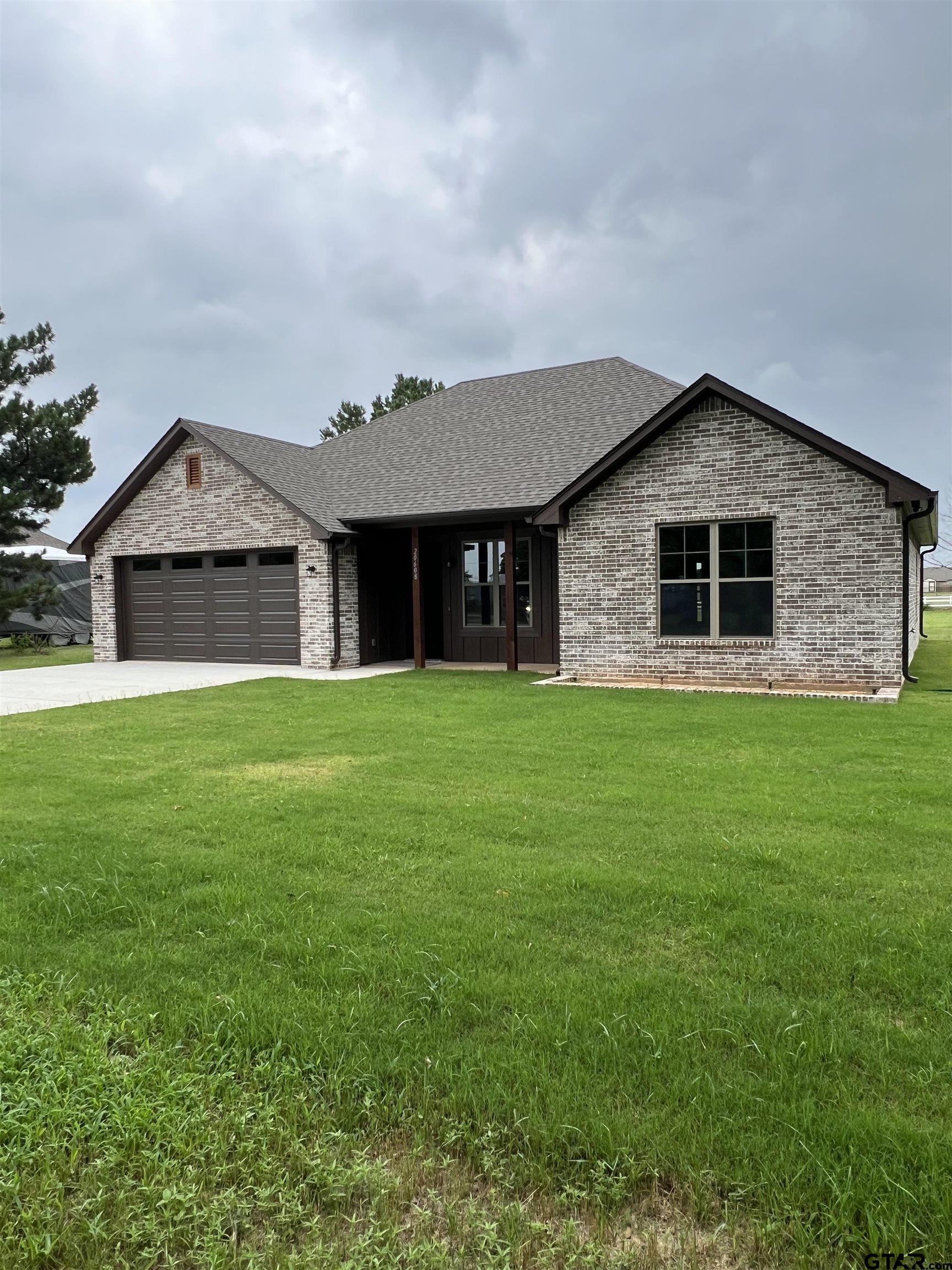 a front view of house with yard and green space