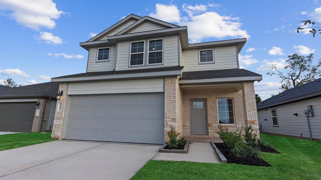 a front view of a house with a yard and garage