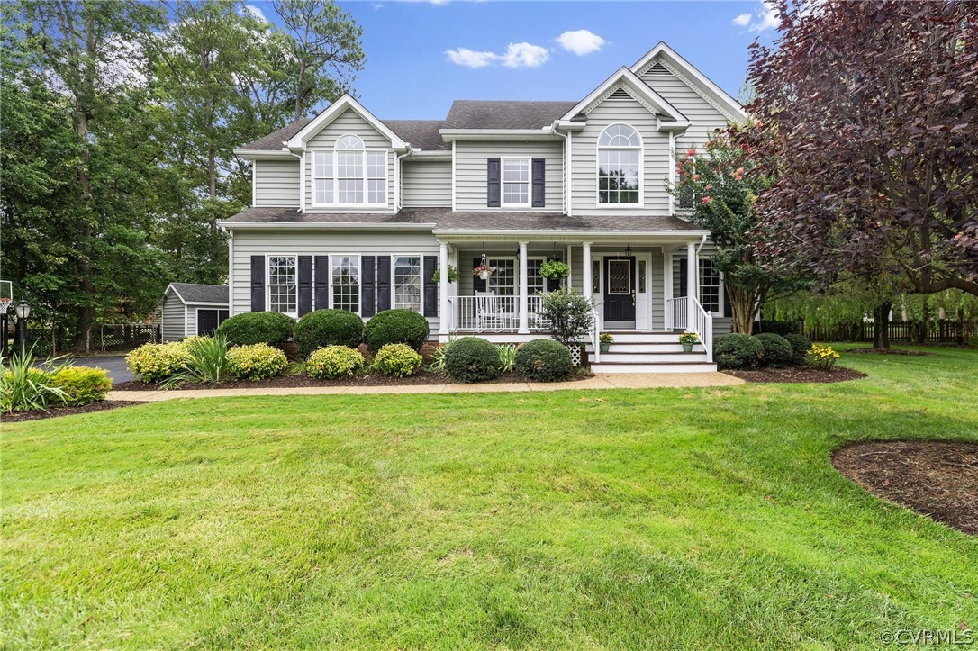 a front view of a house with a yard and trees