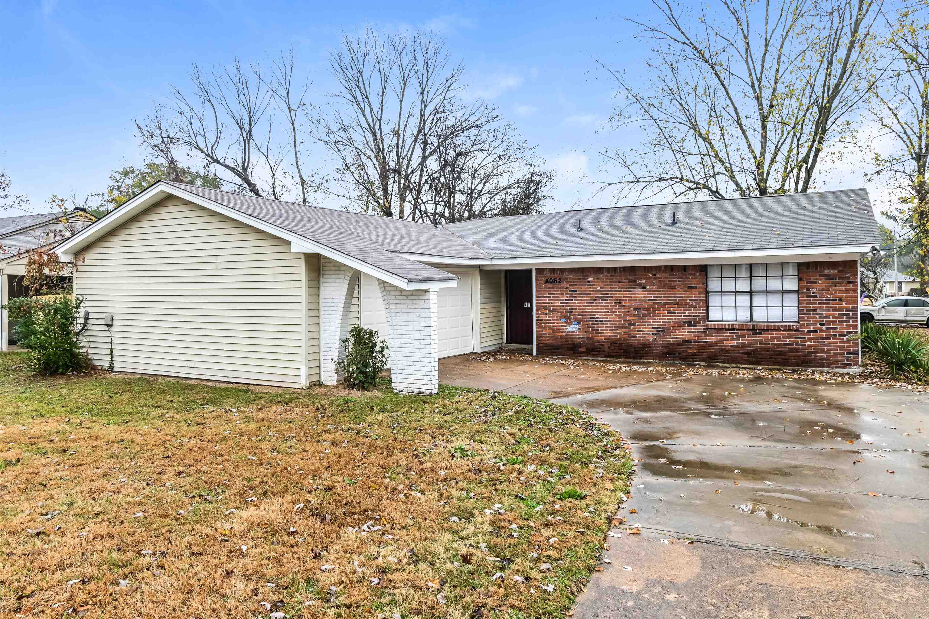 a view of a house with a yard and garage