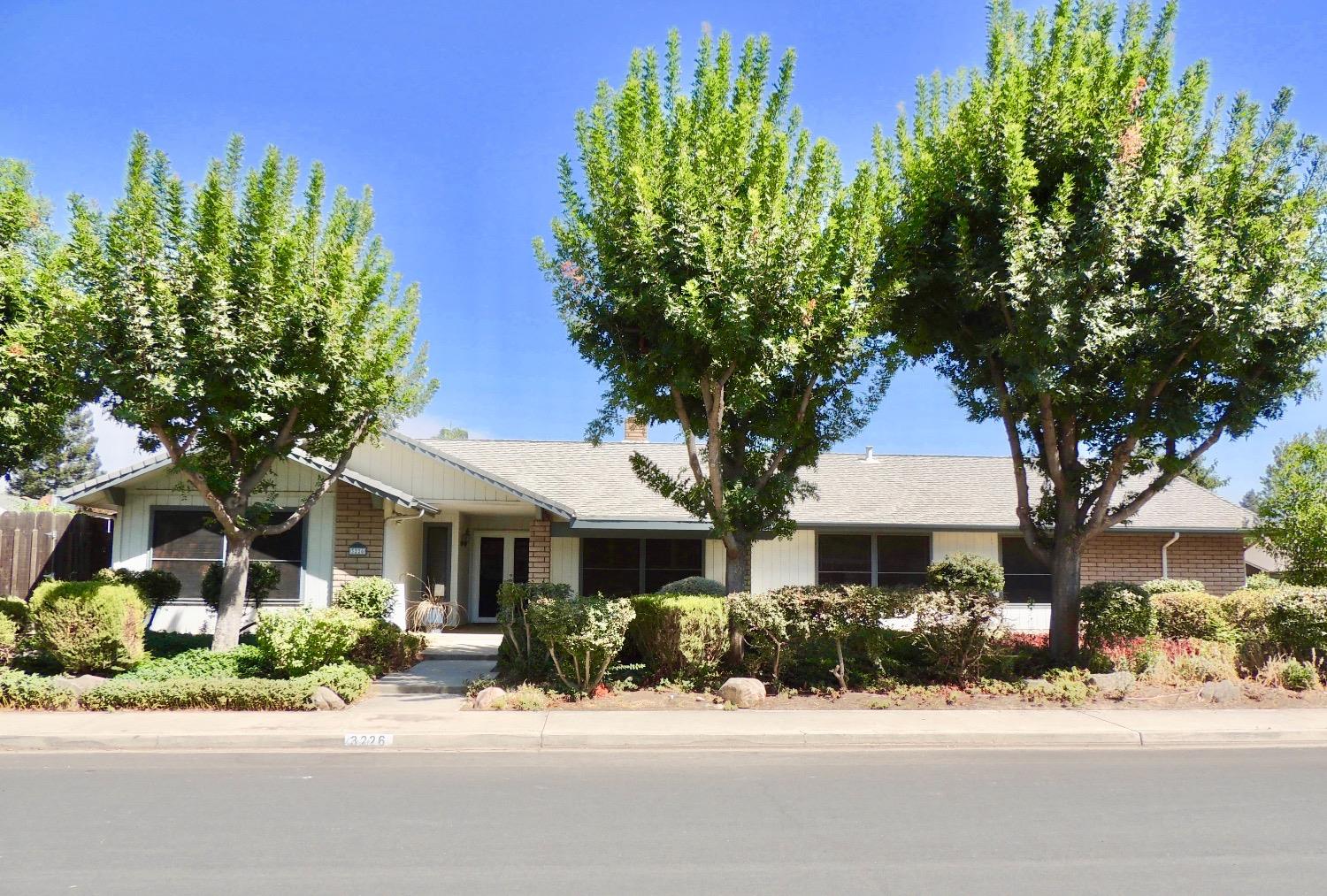 front view of a house with a bench