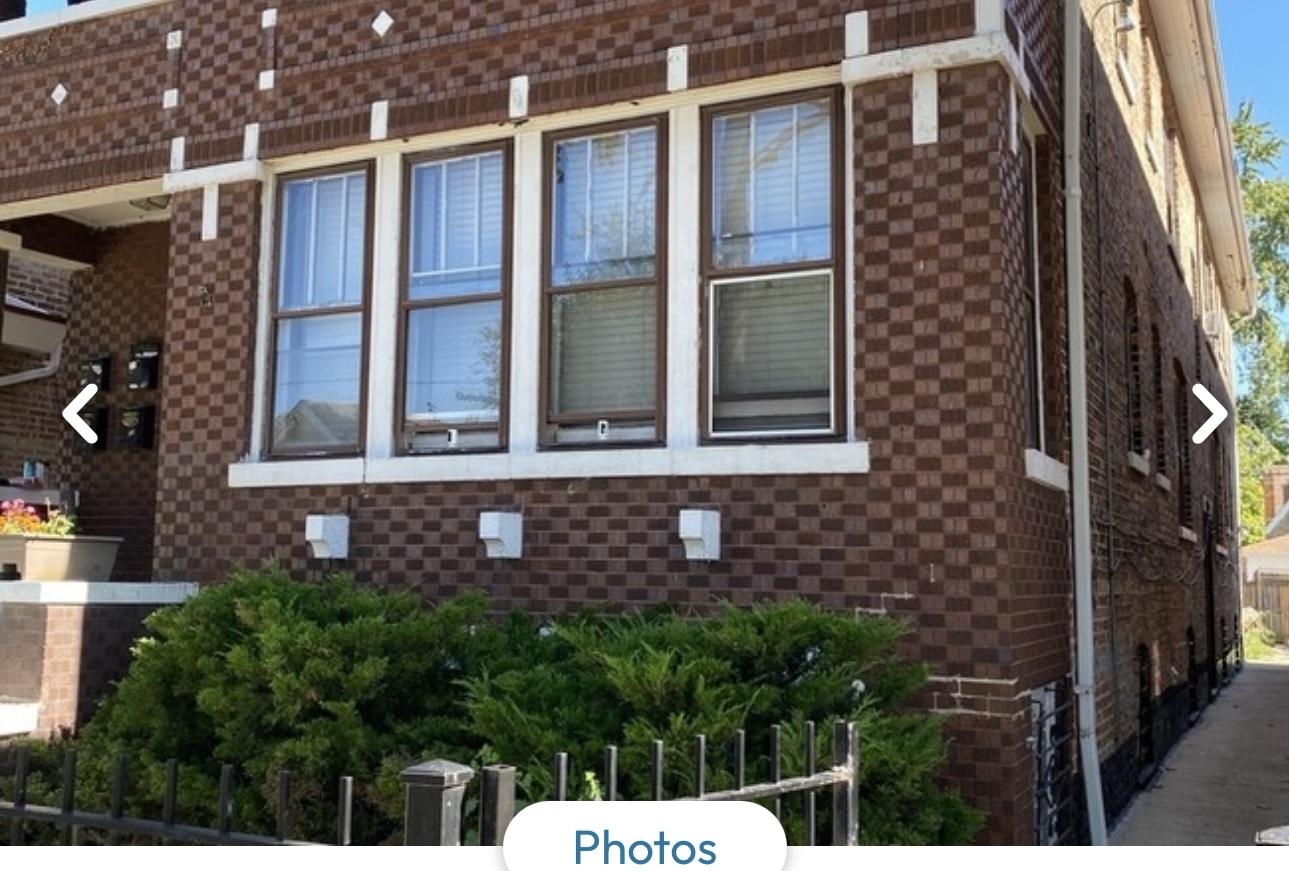 a view of a brick house with a large window