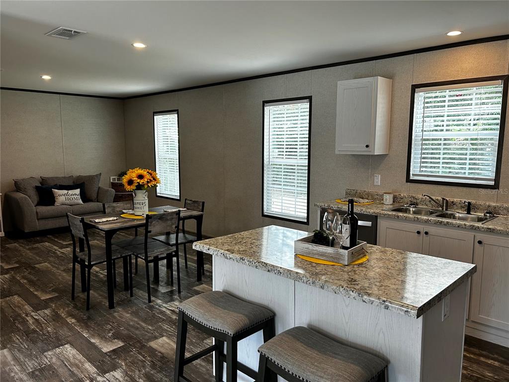 a kitchen with a table chairs and white cabinets