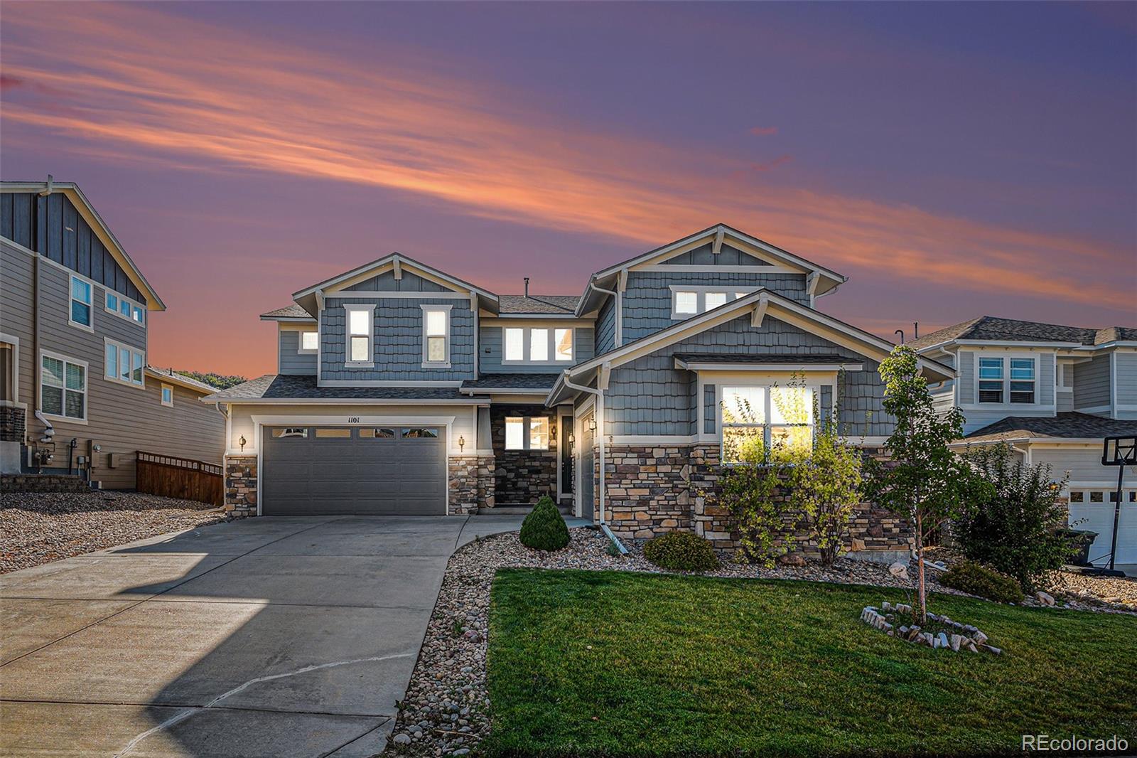 a front view of a house with a yard and garage