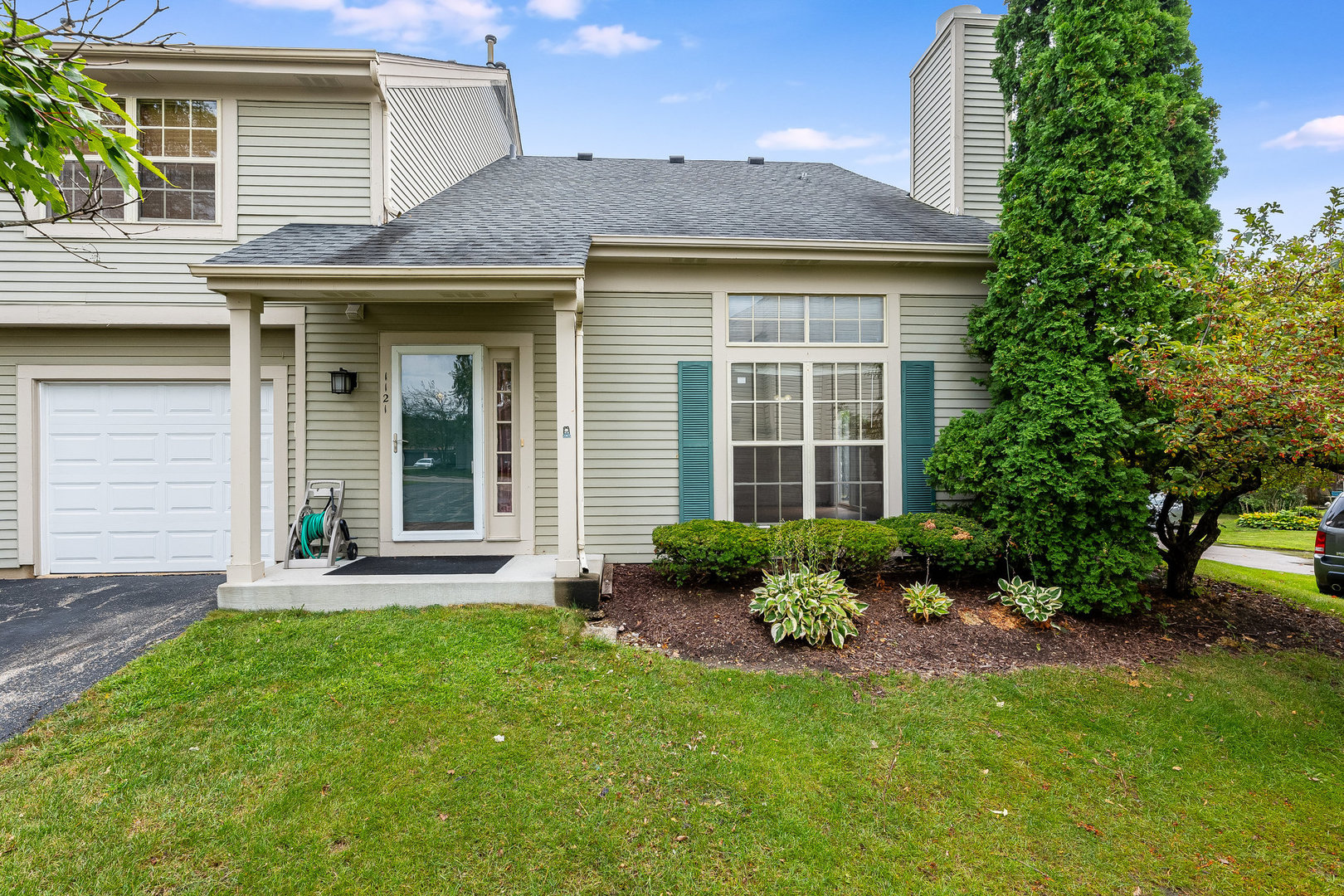 a view of a house with a yard and plants