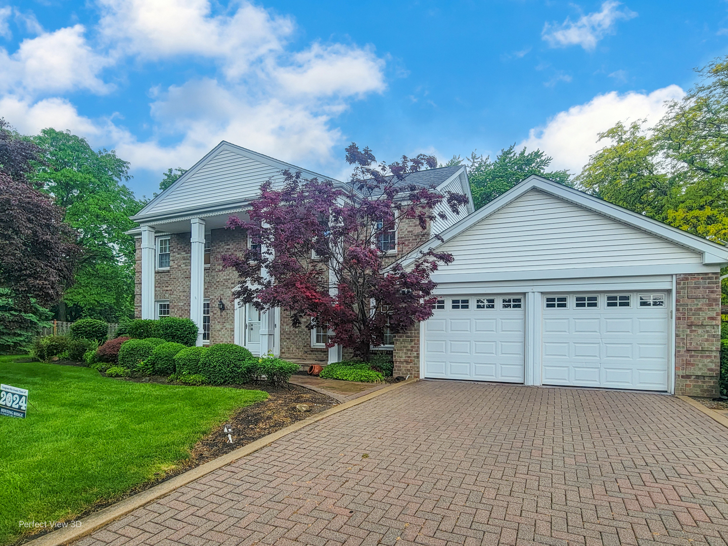 a front view of house with yard and trees