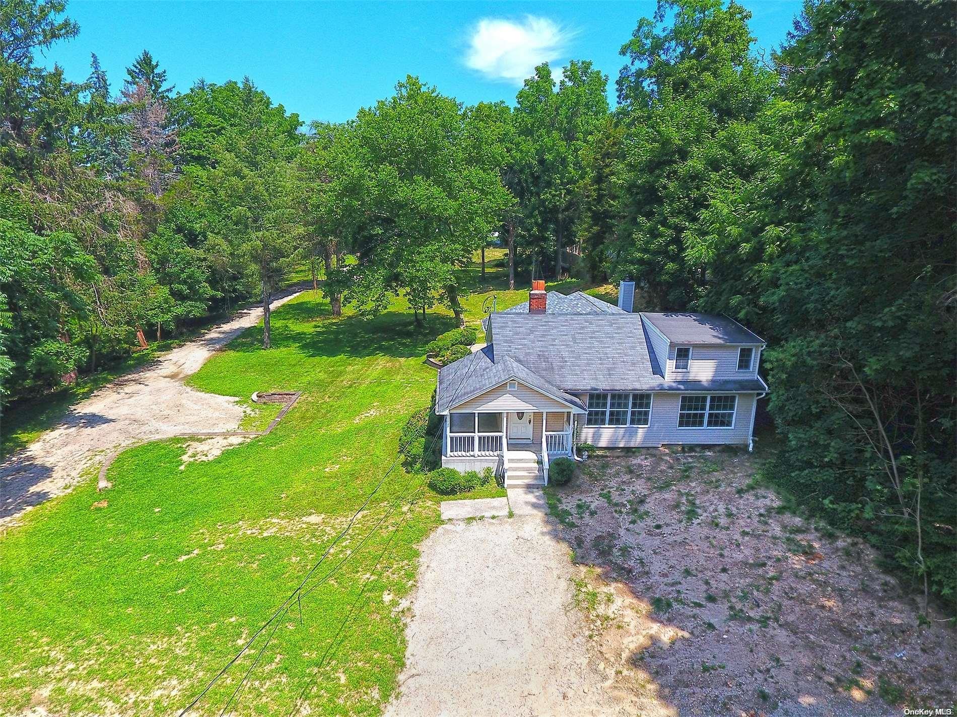 a aerial view of a house with yard and green space