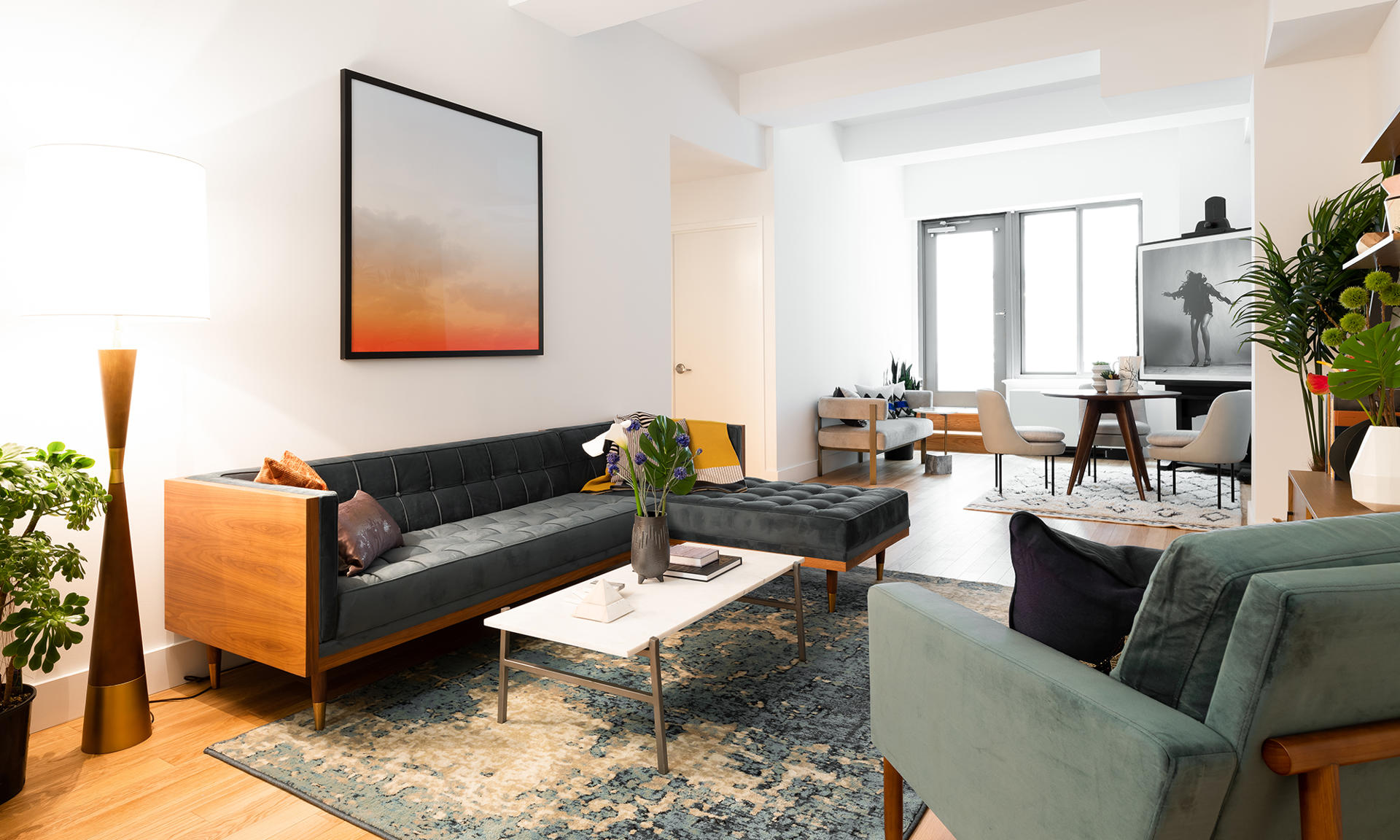 a living room with furniture and a potted plant