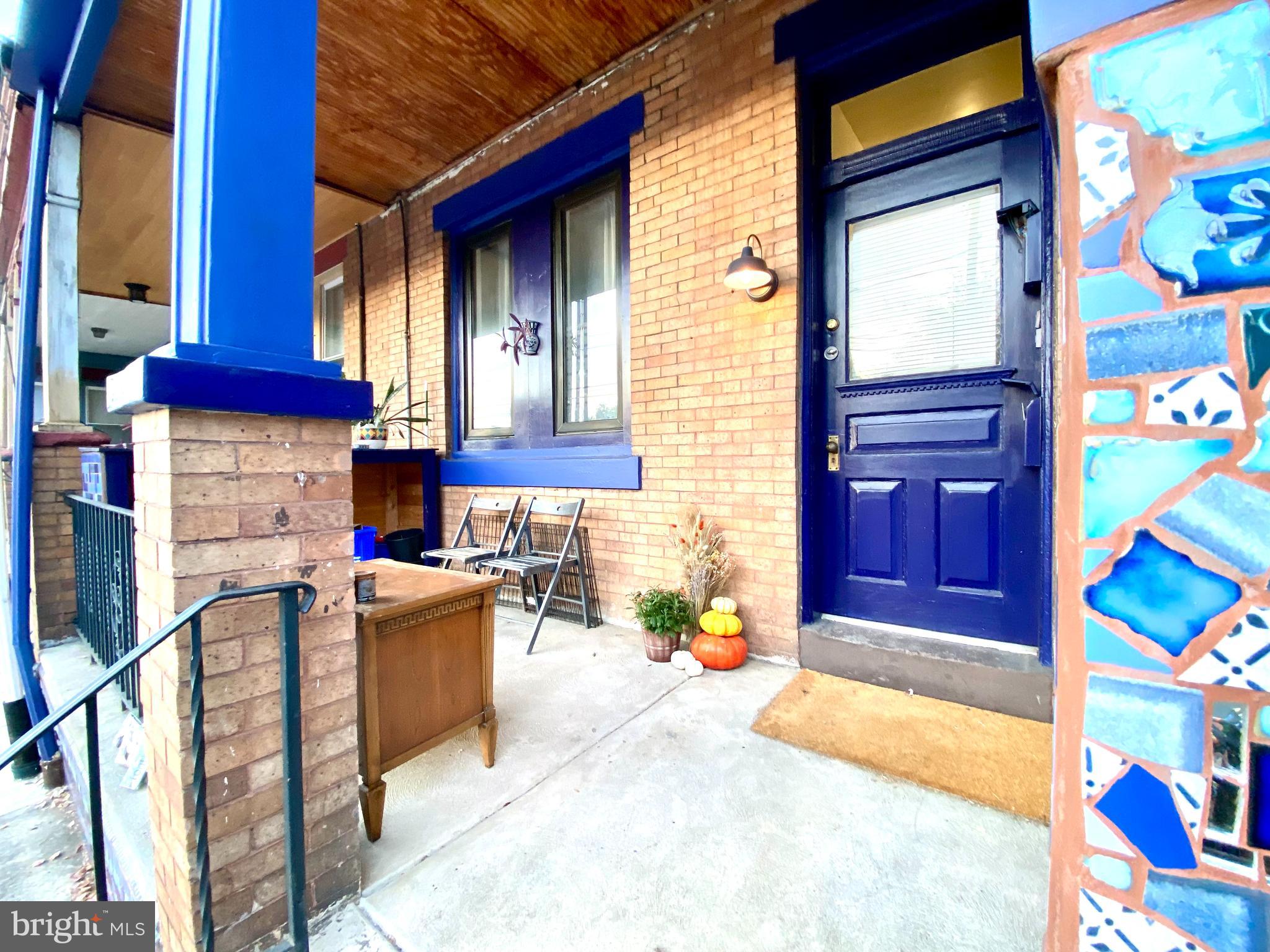 a view of front door of house with outdoor seating