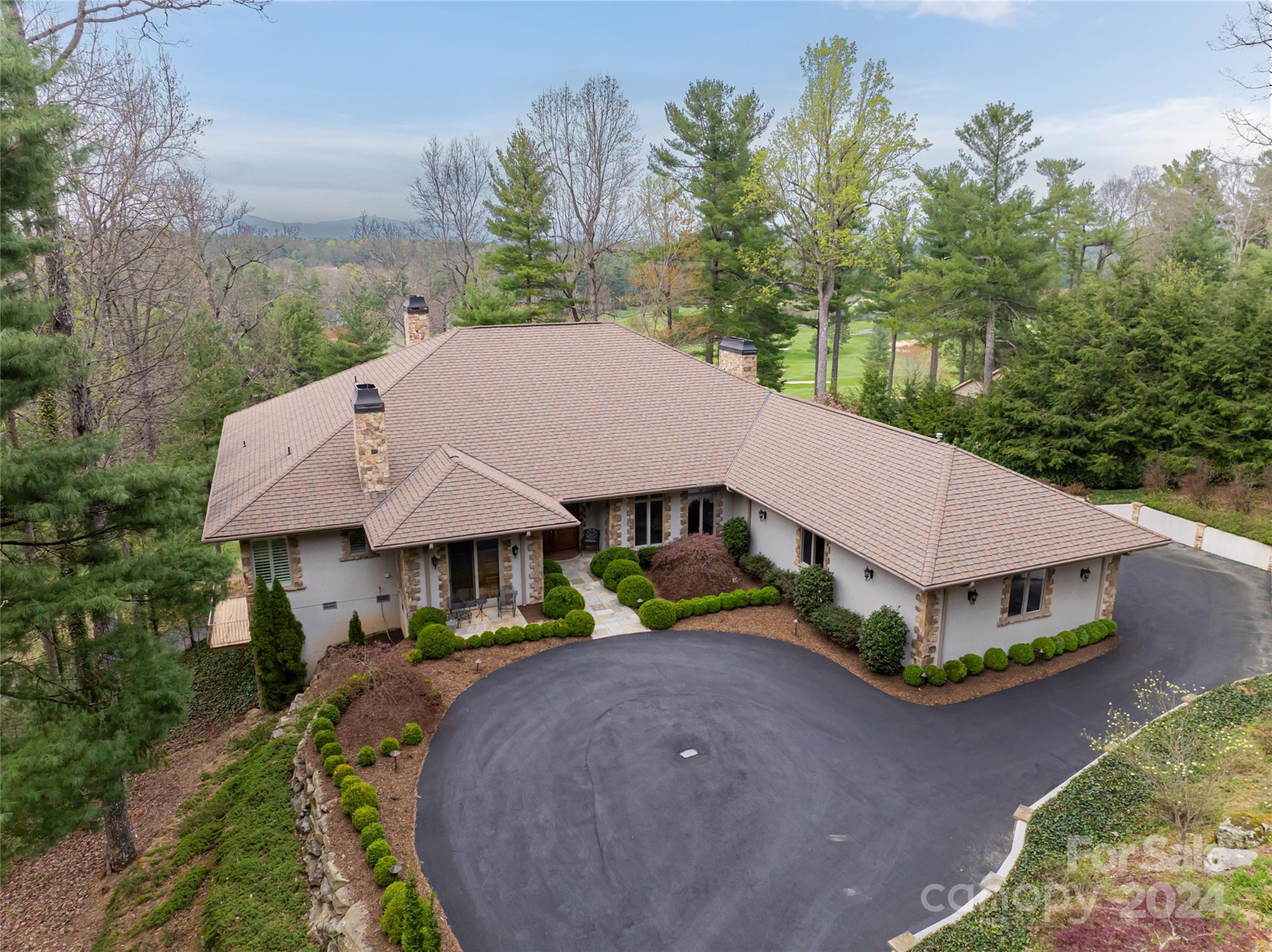 an aerial view of a house with garden space and street view