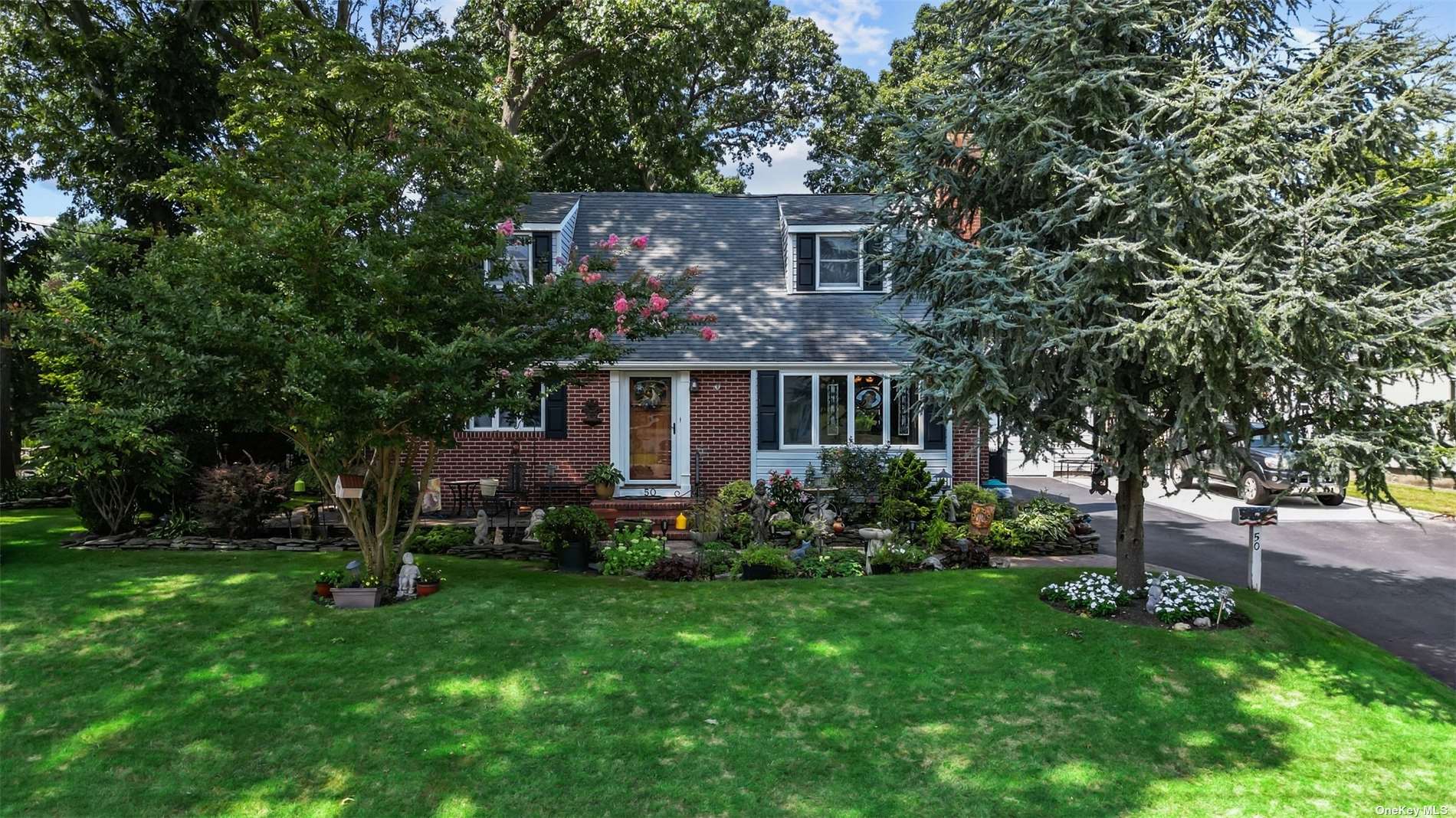 a front view of house with a garden