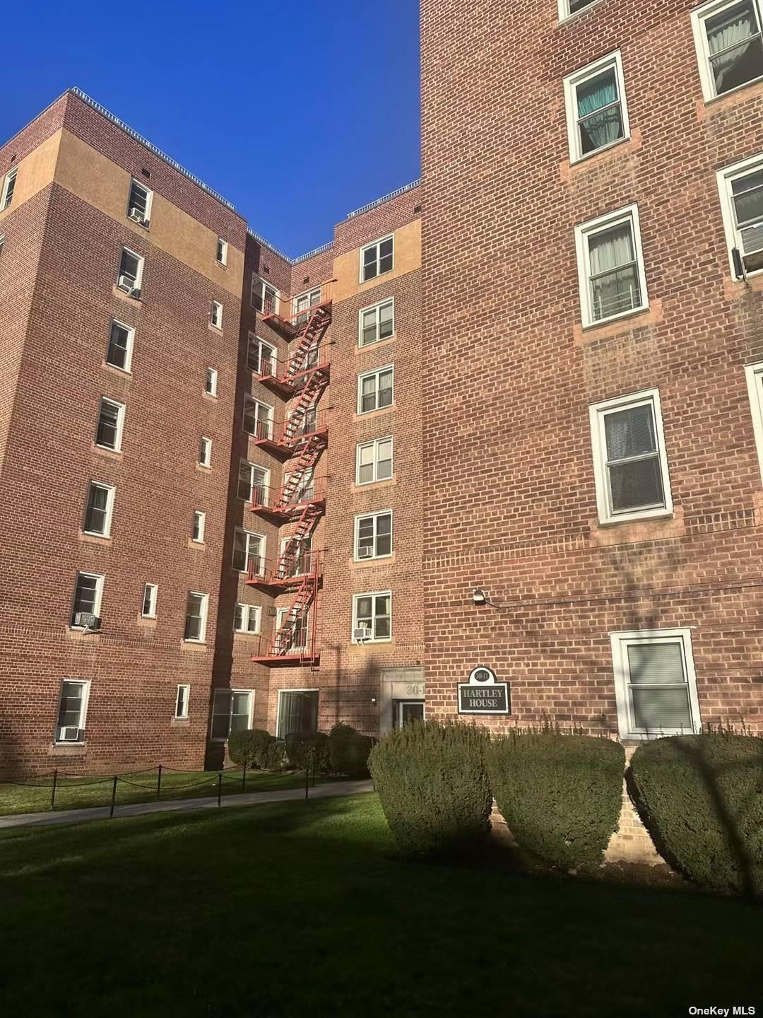 a view of a building next to a big yard