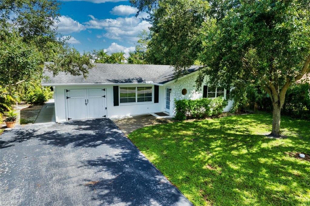 Ranch-style home featuring a front yard