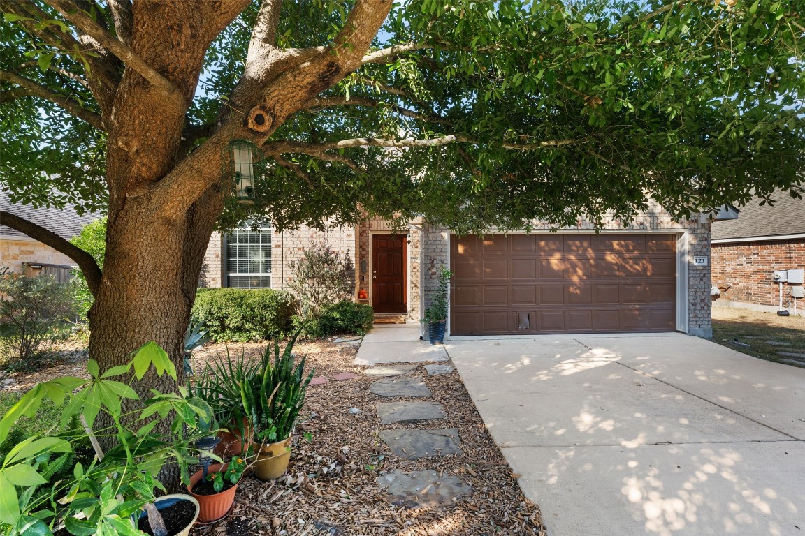 a front view of a house with a yard and a garage