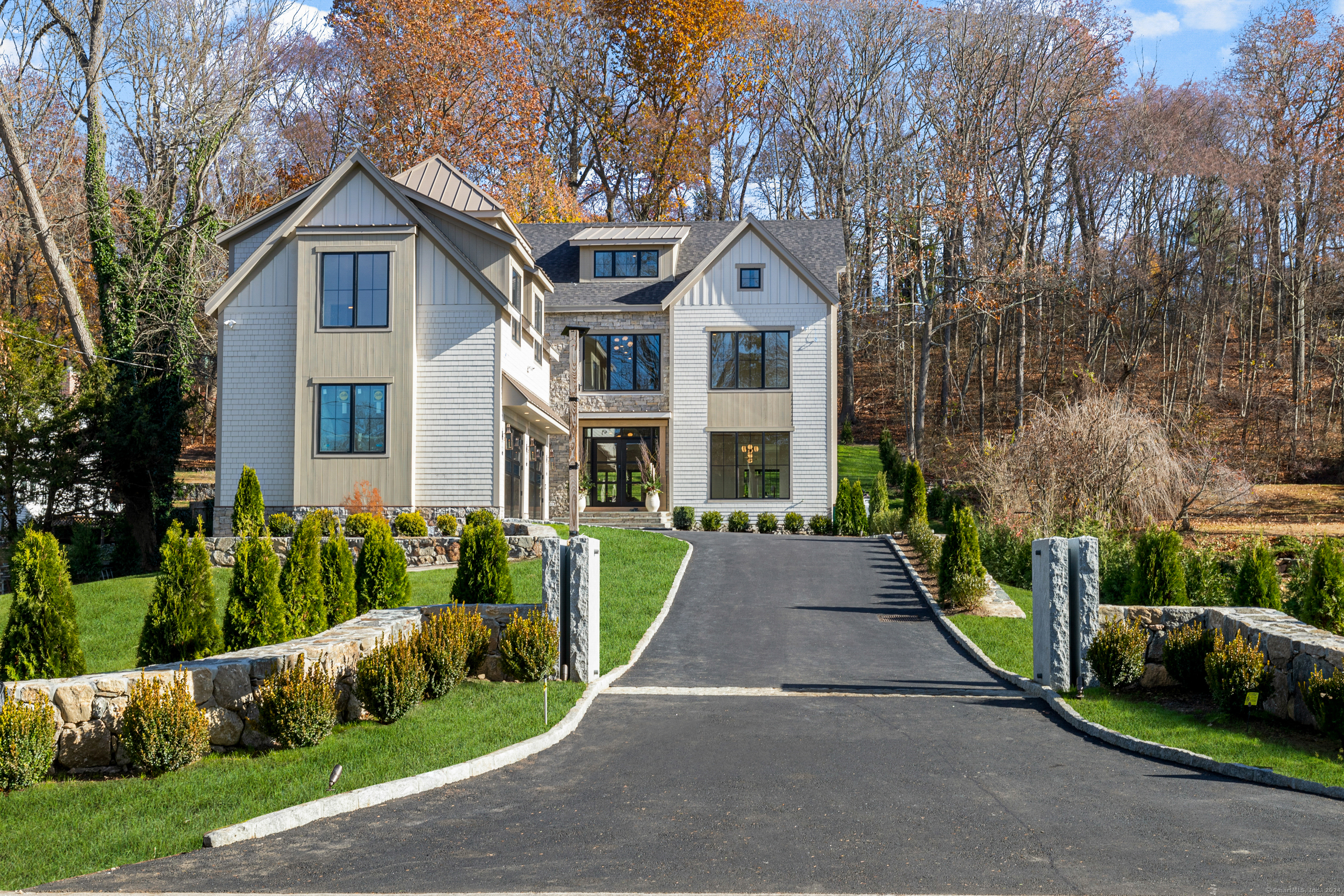 a front view of a house with a yard and potted plants