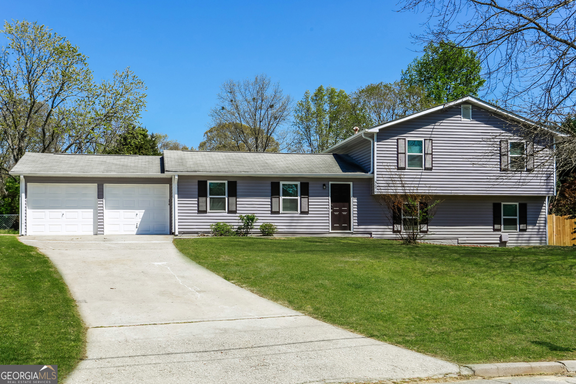 a front view of house with yard and outdoor seating