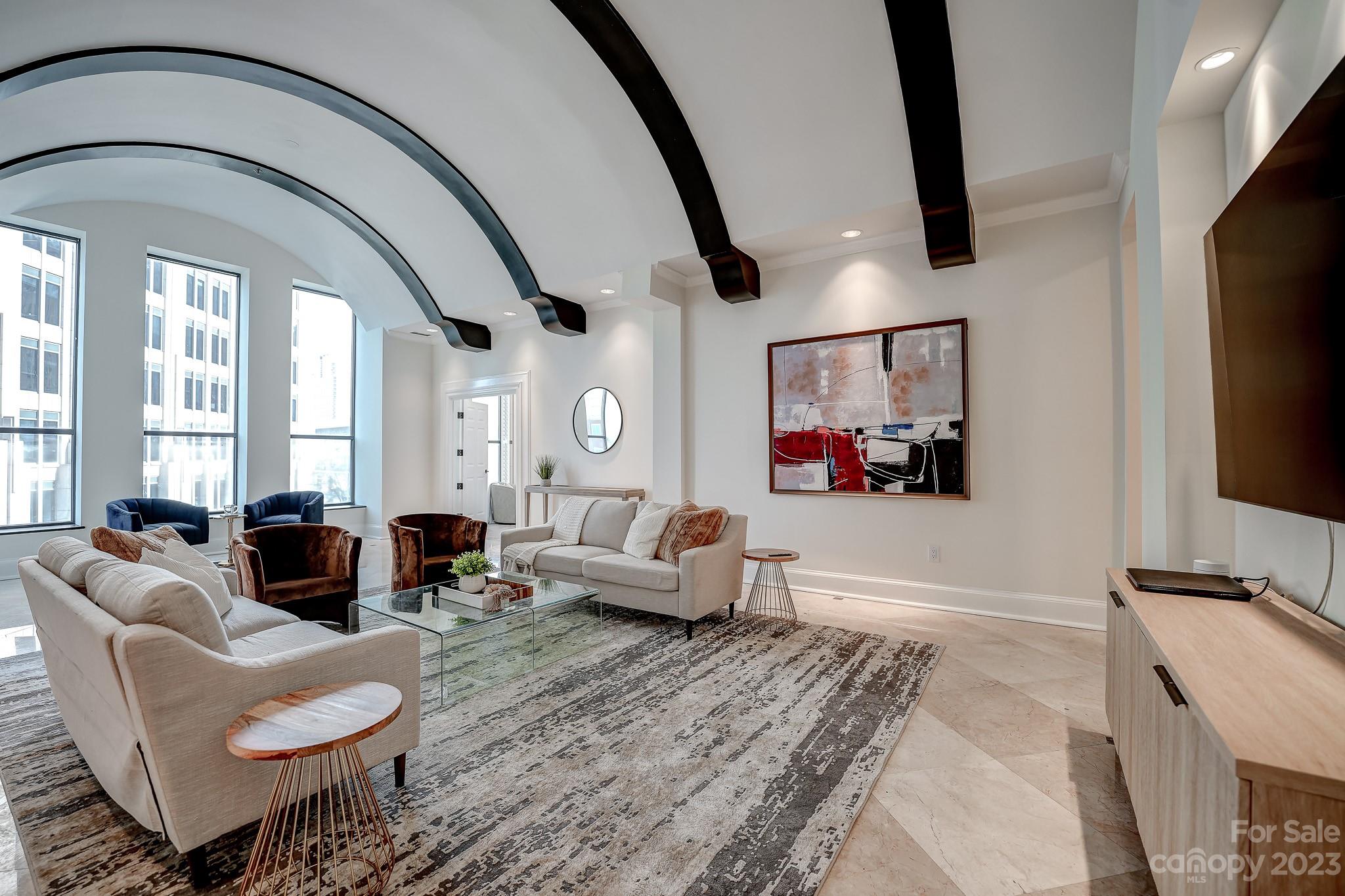 a living room with furniture and a flat screen tv