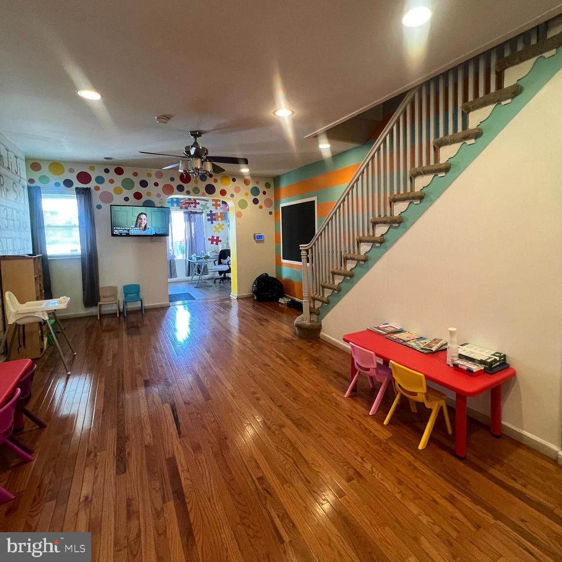 a living room with lots of furniture and wooden floor