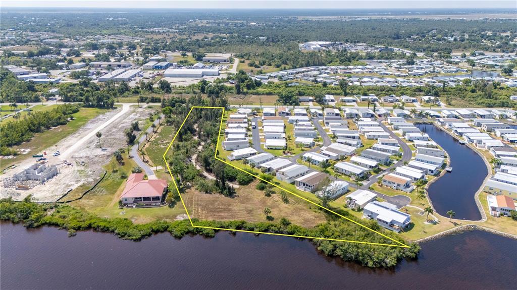 an aerial view of residential houses with outdoor space and trees