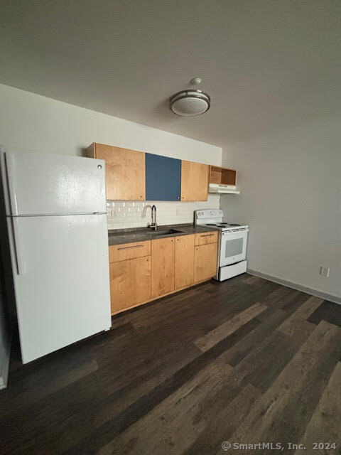 a kitchen with stainless steel appliances a refrigerator and a stove top oven