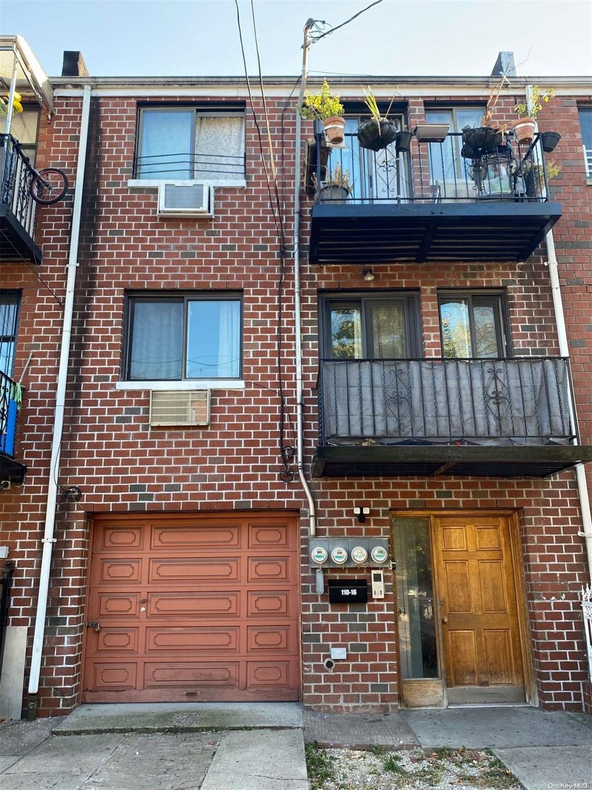 a front view of a house with iron fence