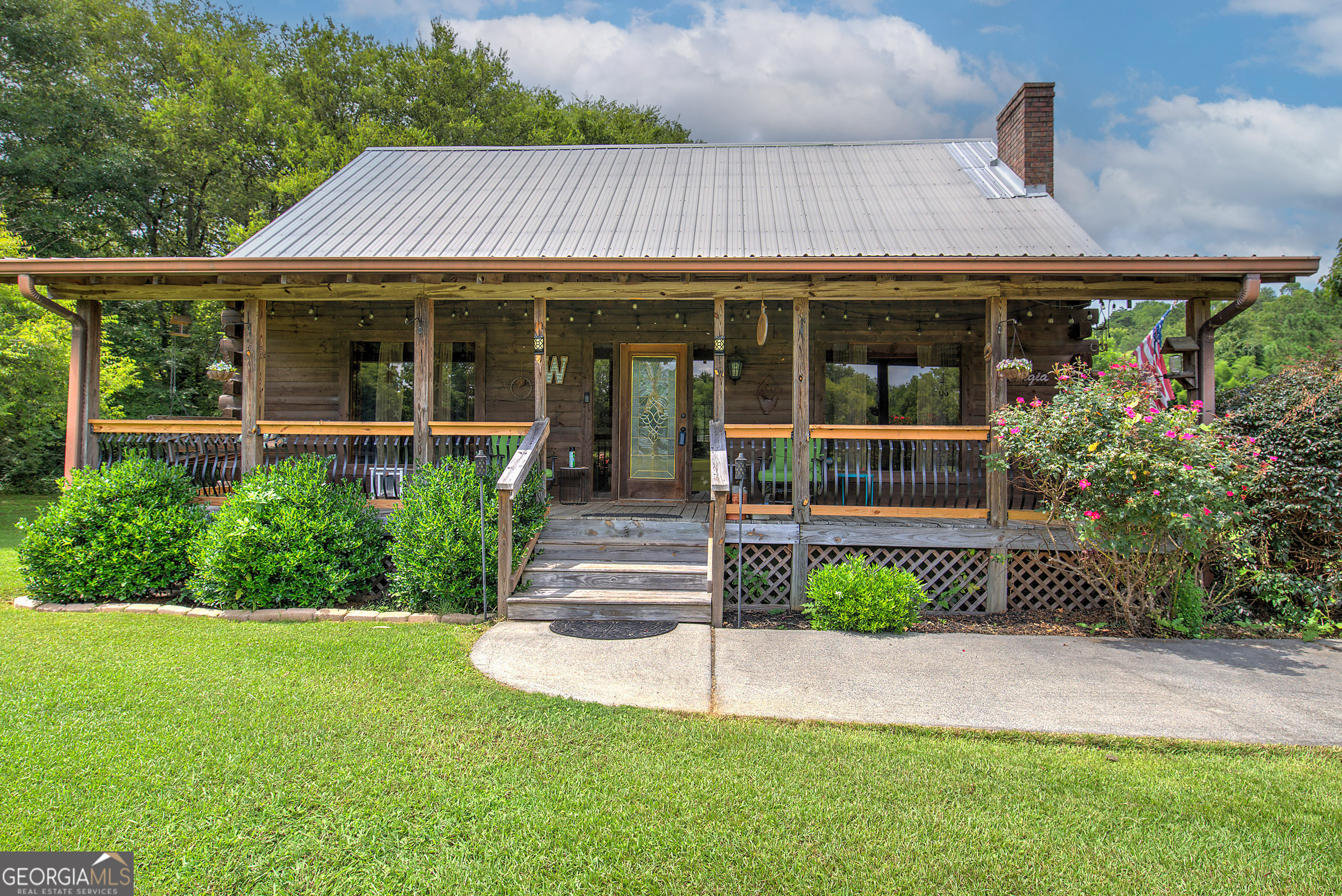 a front view of a house with a garden