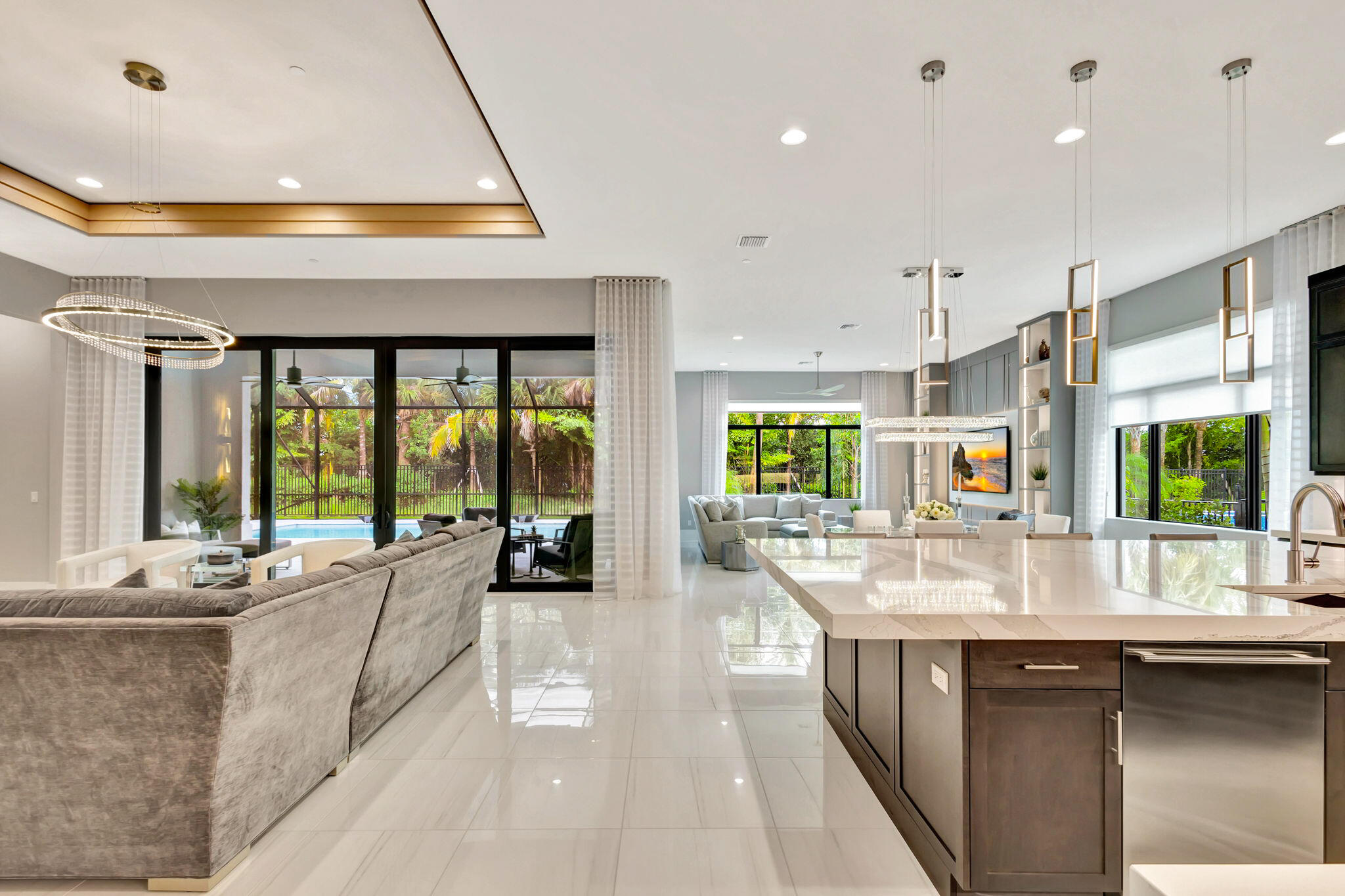 a large kitchen with kitchen island a large window in it