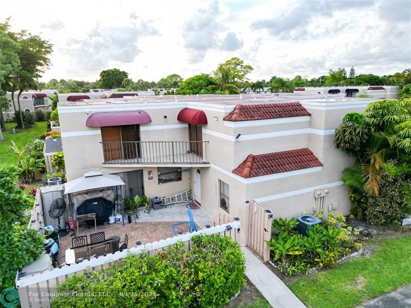 a aerial view of a house with swimming pool garden and patio