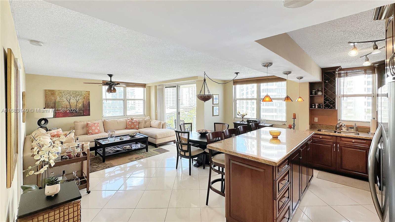 a living room with furniture a large window and a table