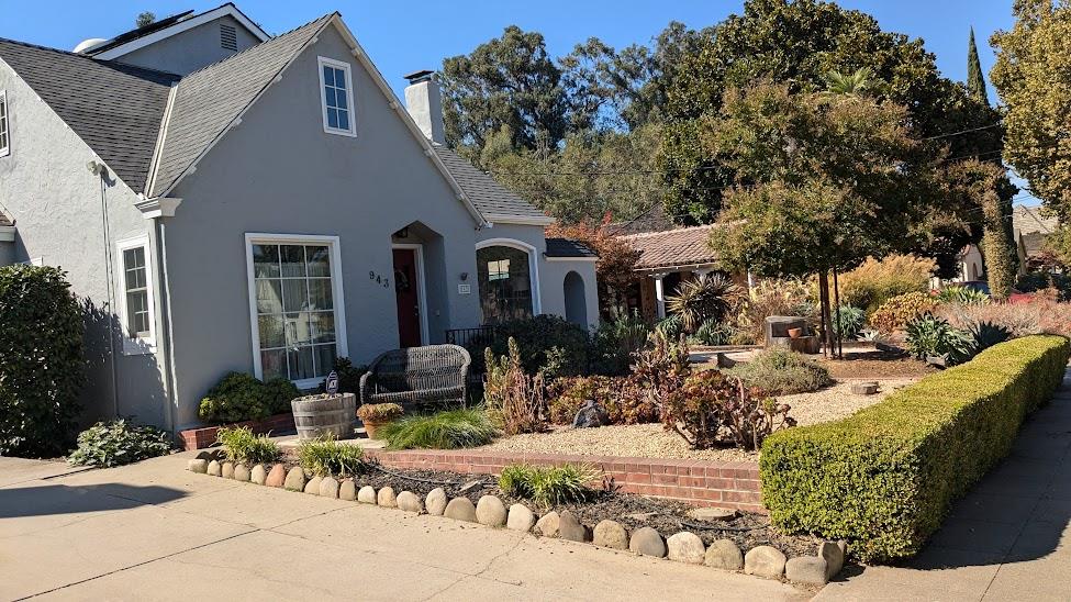 a front view of a house with outdoor seating