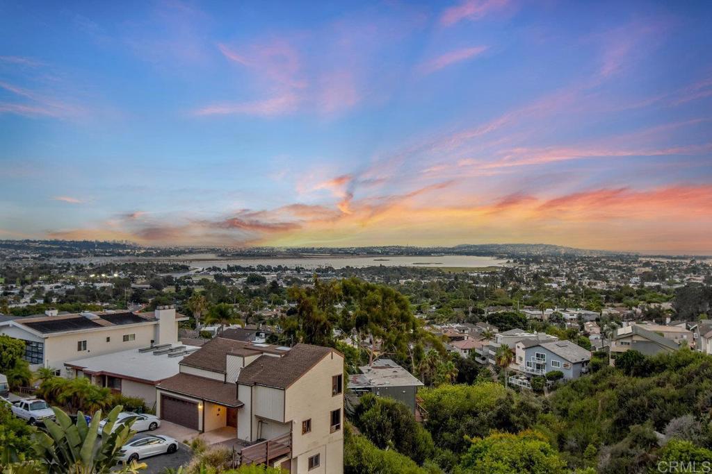 an aerial view of residential houses with city view