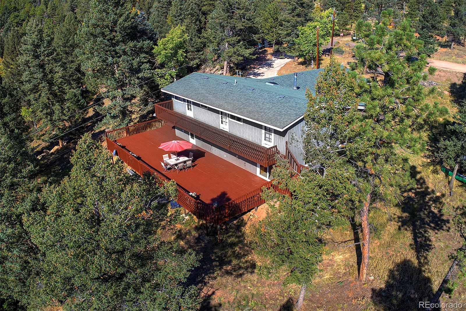 an aerial view of a house with a yard