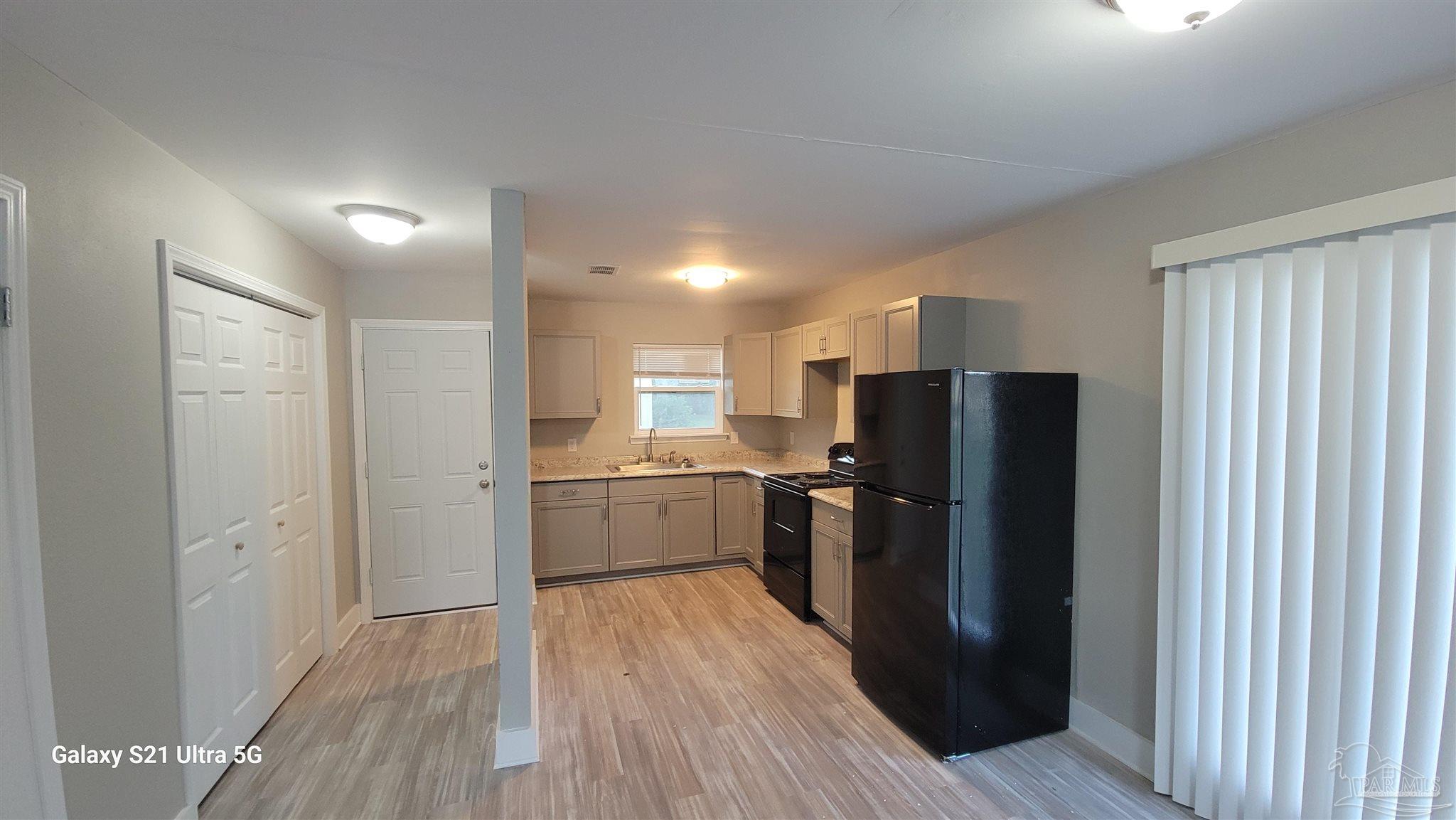 a kitchen with a refrigerator and a sink